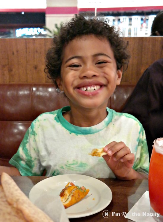 Jaxson eating empanadas at Paladar Latin Kitchen