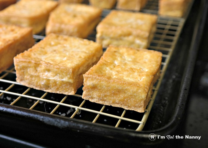 Draining oil from crispy pan fried tofu
